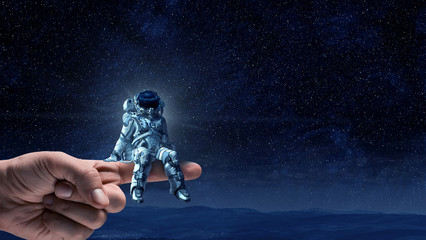 Wall Mural - spaceman on finger. mixed media