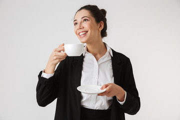 Sticker - Portrait of a smiling young businesswoman drinking tea