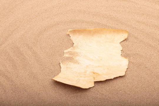 Blank parchment message on the beach
