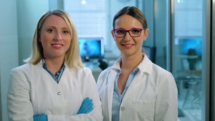Wall Mural - portrait of a team of young female life scientists at a laboratory smiling looking directly at the c