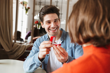 Sticker - Smiling young man proposing to a woman