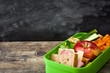 Healthy school lunch box: Sandwich, vegetables and fruit on wooden table. Copyspace