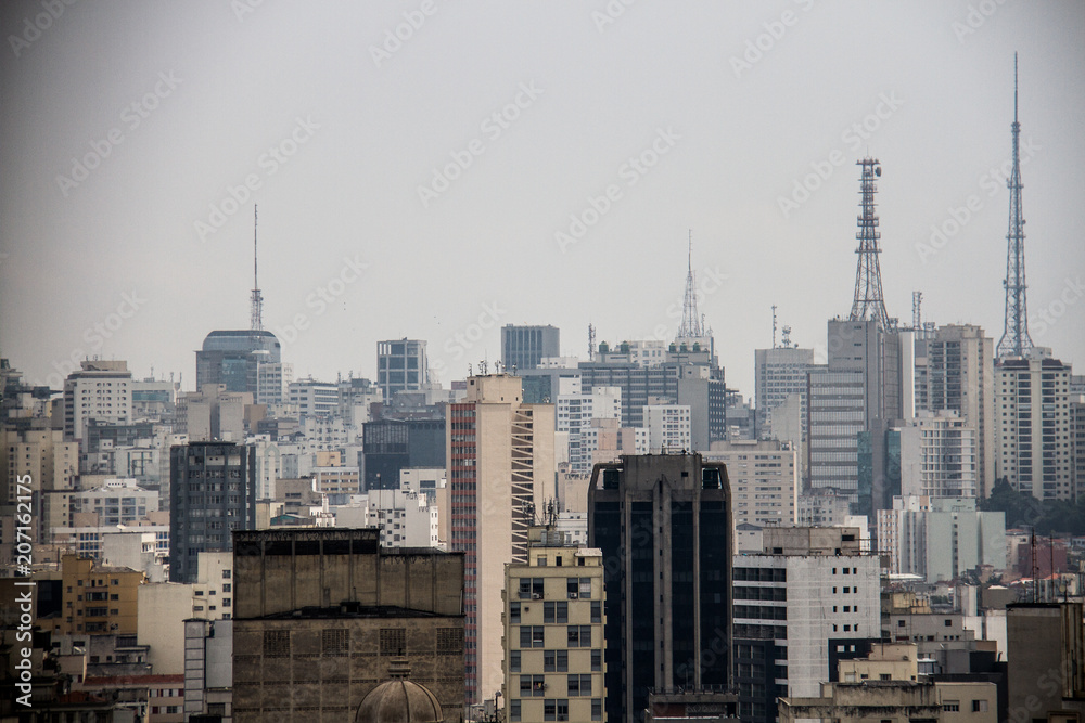 TV antennas on top of buildings in a metropolis skyline - obrazy, fototapety, plakaty 