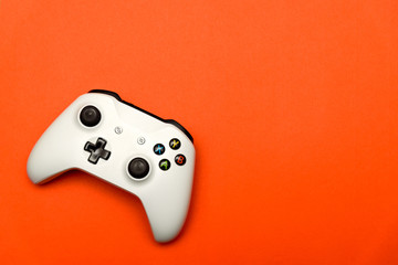 White joystick on orange textured background. Computer gaming competition videogame control confrontation concept