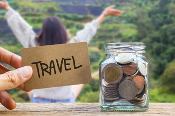 Conceptual saving money for travel with blurred happy time vacation as background.