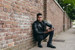 © ADDICTIVE STOCK - Black man posing on brick wall
