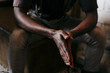 © ADDICTIVE STOCK - Black man folding hands together