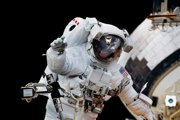 Wall Mural - Close up of an astronaut waving hi to the camera.Elements of this image furnished by NASA.