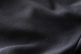 Fototapeta Miasta - Close-up polyester fabric texture of black athletic shirt
