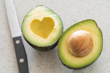 Fresh Cut Avocado With Heart Shaped Pit Area On Wooden Cutting Board