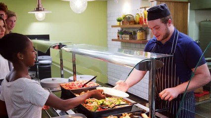 Wall Mural - Teenage Students Being Served Meal In School Canteen