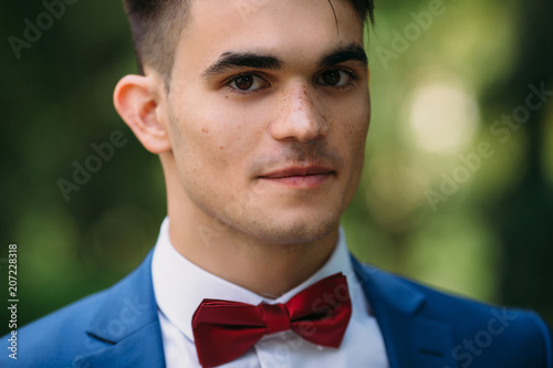 A Close Up Dark Haired Guy With Thick Eyebrows Brown Eyes And