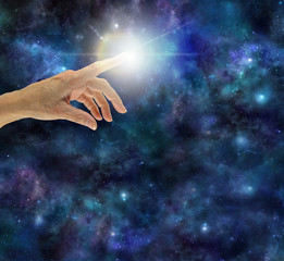 Wall Mural - the creative spark of universal intelligence - female hand with index finger touching a bright white
