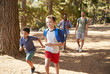 © Monkey Business - Boys Running Ahead Of Fathers On Hiking Adventure