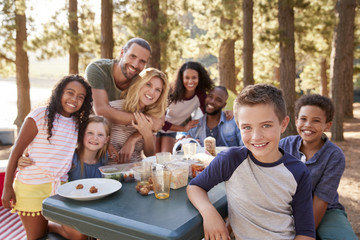 Wall Mural - Portrait Of Family With Friends Camping By Lake In Forest