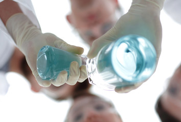 Wall Mural - image is blurred. beakers in hand, and scientists