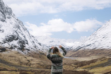 Happy Girl In Knitted Wool Sweather Dancing And Enjoying A Mountain View In Glen Coe, Scotland