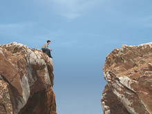 Young Man On A Rock In Front Of A Chasm.