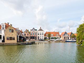 Wall Mural - Harbour with boats and quayside with houses in old town of Makkum, Friesland, Netherlands