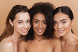 Close up image of three happy naked women posing together