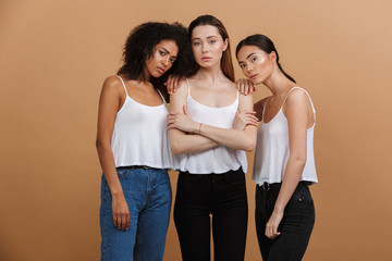 Wall Mural - image of three beautiful international women: caucasian, african american and asian girls in casual 
