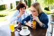 © Alvin Harambašić - Young romantic couple spending time together - sitting in cafe's garden, drinking juice and having fun