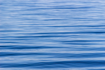 Surface with waves of the blue sea, background, texture