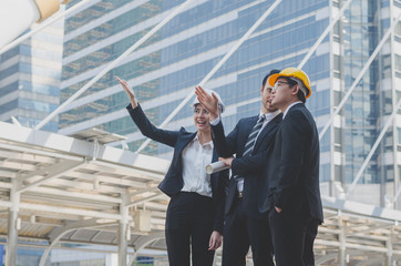 engineer team with business man at outdoor construction site in city with talking and discussion about planning project progress to successful construction business property estate investment.