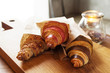 © Ogovorka - fresh croissants with jam and almonds for breakfast