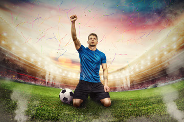 Wall Mural - Football player exults in a stadium with audience