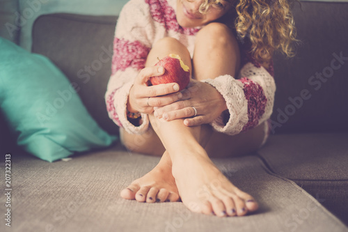 Fotografie, Obraz tenderness concept with beautiful caucasian curly hair woman smiling and eating an apple fruit to take care of her health and body