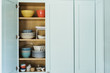 © Jamie Grill Photography/Tetra Images - Dishes in cupboard