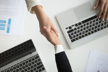 Poster - Female hands shaking at meeting making partnership deal, businesswomen handshaking as concept of respect, successful teamwork, collaboration and support, women power in business, top close up view