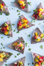 Blue Corn Tortilla Chips With Mango Salsa On A Blue Background