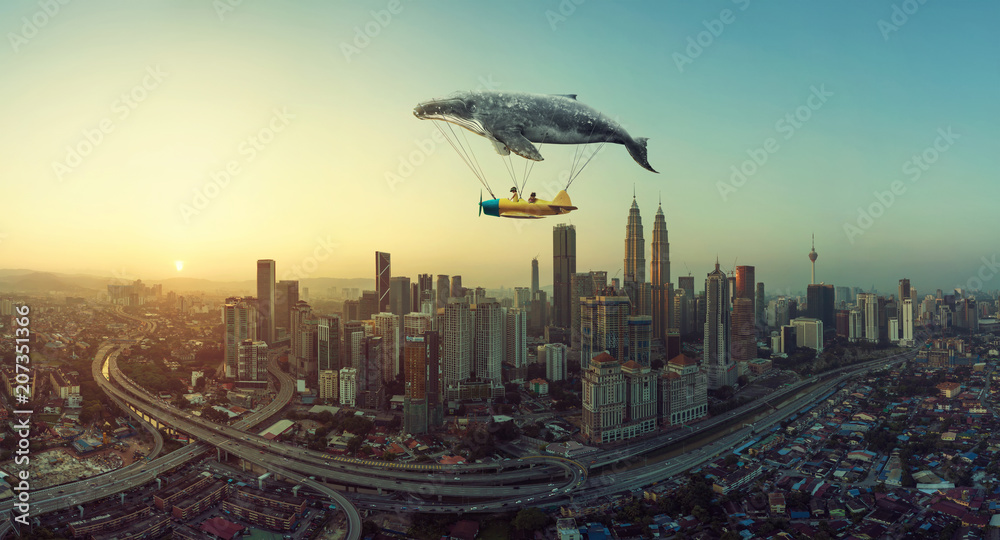 Fotografija Whale floats in the sky and carrying a plane with two young little sister
