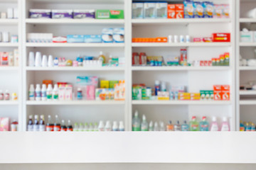 Wall Mural - Pharmacy drugstore counter table with blur abstract backbround with medicine and healthcare product on shelves