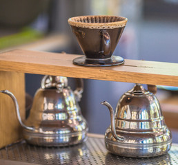 Drip brewing, filtered coffee, or pour-over is a method which involves pouring water over roasted, ground coffee beans contained in a filter, Drip or brewed coffee on paper dripping bag on a cup