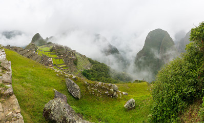 Wall Mural - View of Machu Picchu's citadel, without tourists, on a foggy day