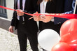 © Andrey Popov - Businesspeople Hand Cutting Red Ribbon