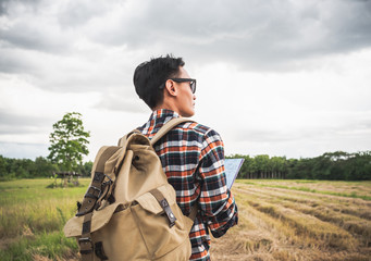 Wall Mural - A man travel outdoor nature with storm cloudy background.