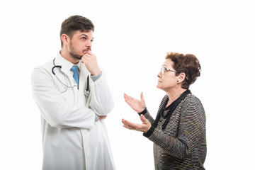 Female senior patient explaining something to male doctor