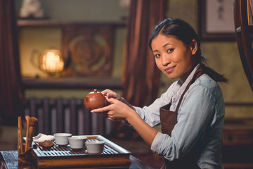 Young tea master in room