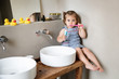 © Lisa Tichané - Toddler brushing teeth on bathroom counter