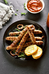 Canvas Print - Fried sausage in frying pan