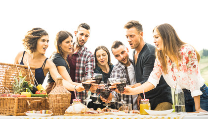 Sticker - Young friends having fun outdoors drinking red wine at barbecue - Happy people eating healthy food at harvest time in farmhouse vineyard winery - Youth friendship concept on warm vintage filter