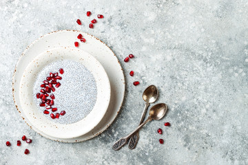 Wall Mural - Healthy breakfast set. Chia seed pudding bowls with pomegranate.