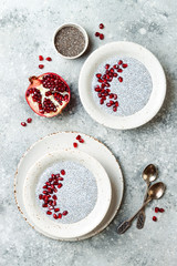 Wall Mural - Healthy breakfast set. Chia seed pudding bowls with pomegranate.