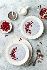 Wall Mural - Healthy breakfast set. Chia seed pudding bowls with pomegranate.