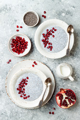 Wall Mural - Healthy breakfast set. Chia seed pudding bowls with pomegranate.