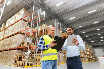 Poster - wholesale, logistic business and people concept - warehouse worker and businessman with clipboard and tablet pc computer